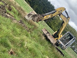 Excavator creating drainage track